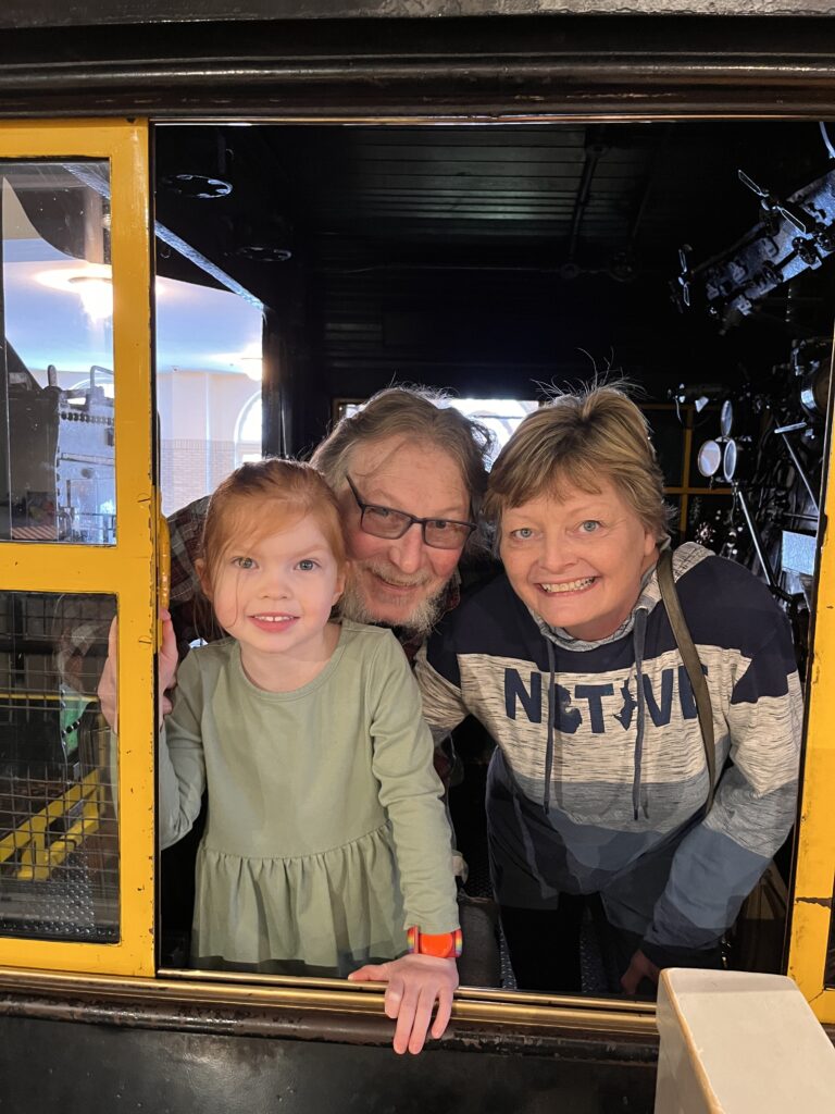 Riley and my parents at Henry Ford inside of a train.