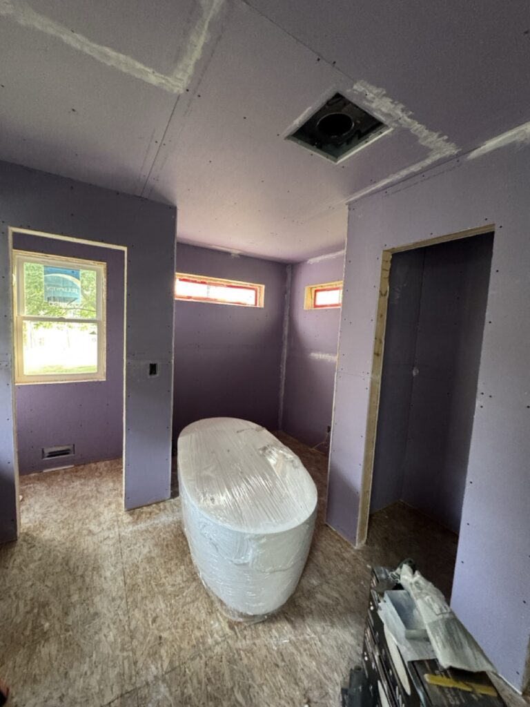 interior shot showing the drywall in the toilet, tub and linen closet.
