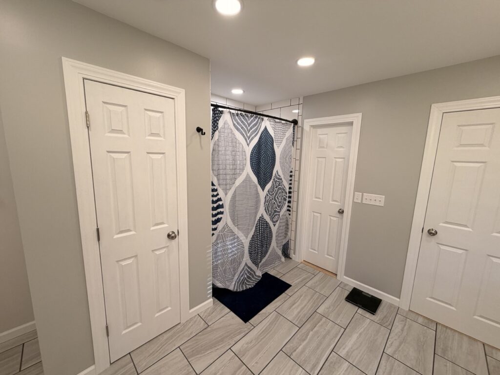 image of linen closet, shower and remainder of bathroom