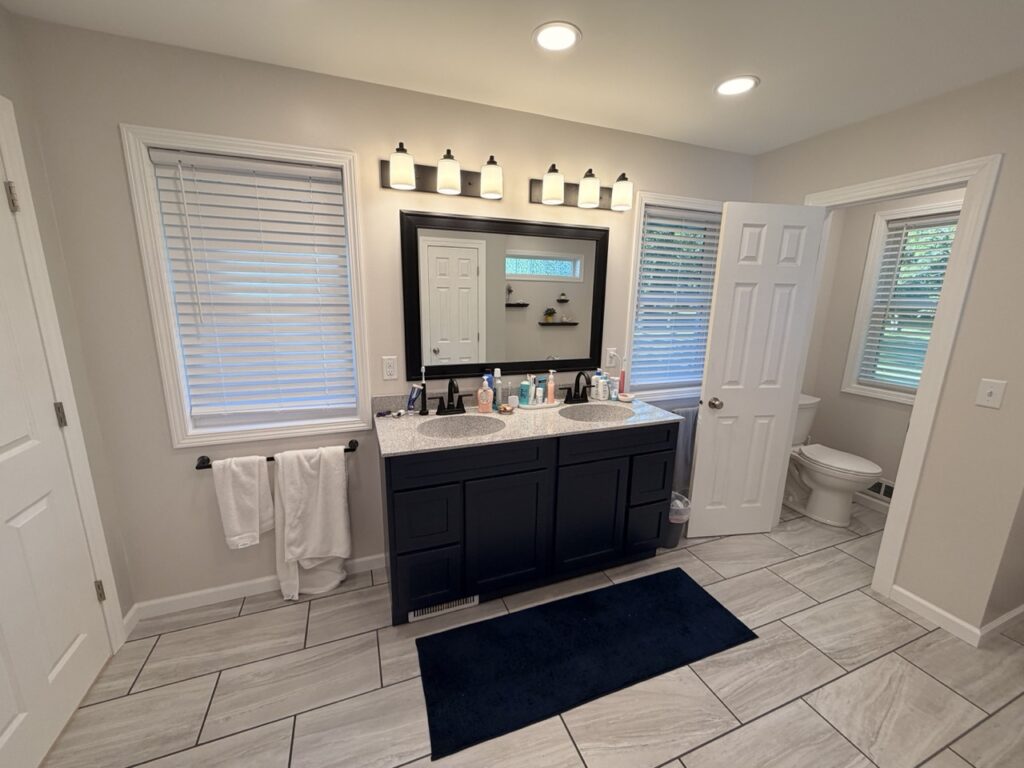 Image of vanity, windows and toilet room.